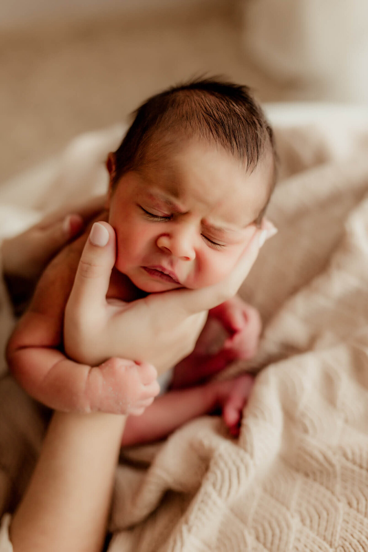 Mother holds her son for a burp pose.