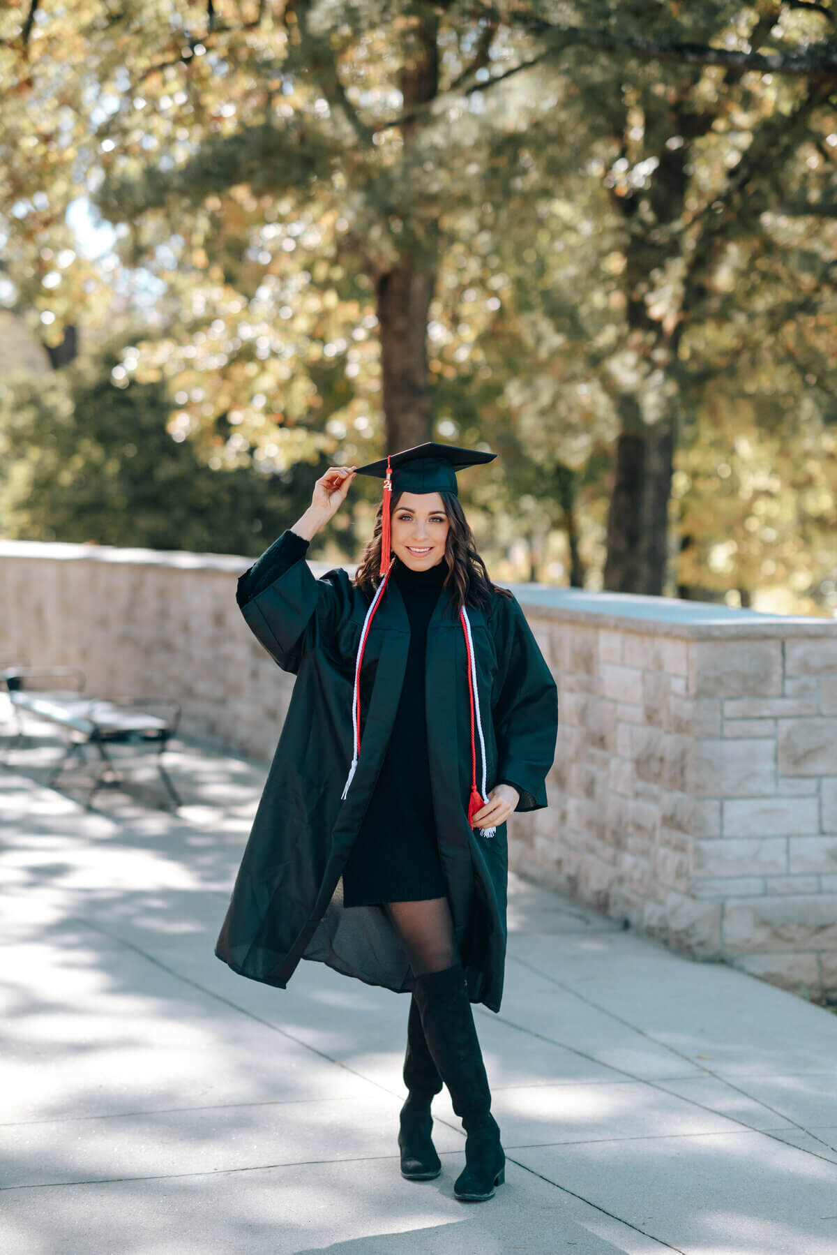 image of senior wearing graduation gown and cap by senior photographer