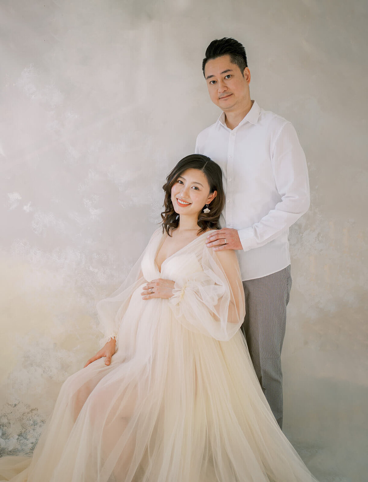 Embrace maternity's radiance with a Chinese descent mum in a breathtaking cream tulle gown, capturing moments at a Gold Coast studio