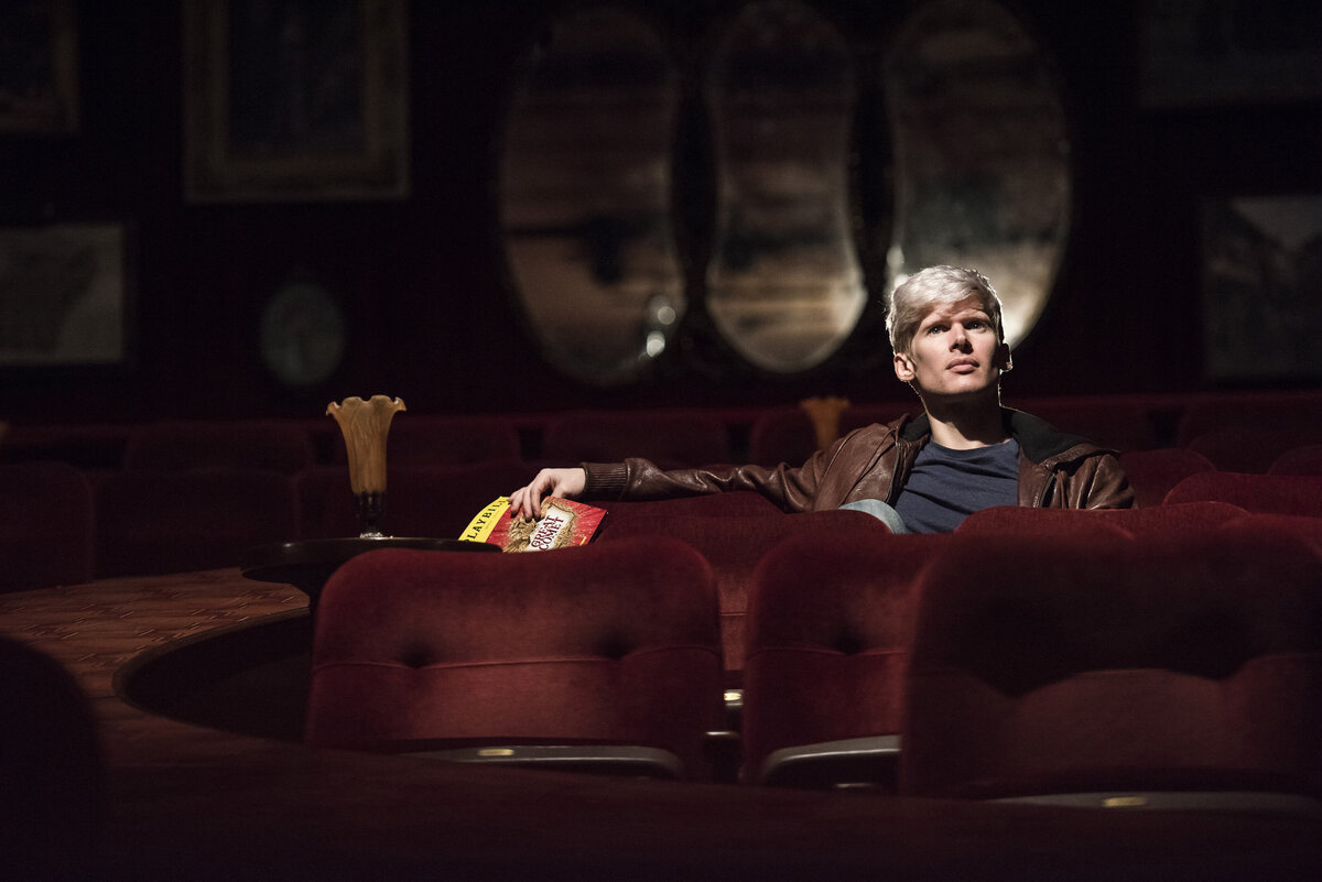 A single person sitting in a theater