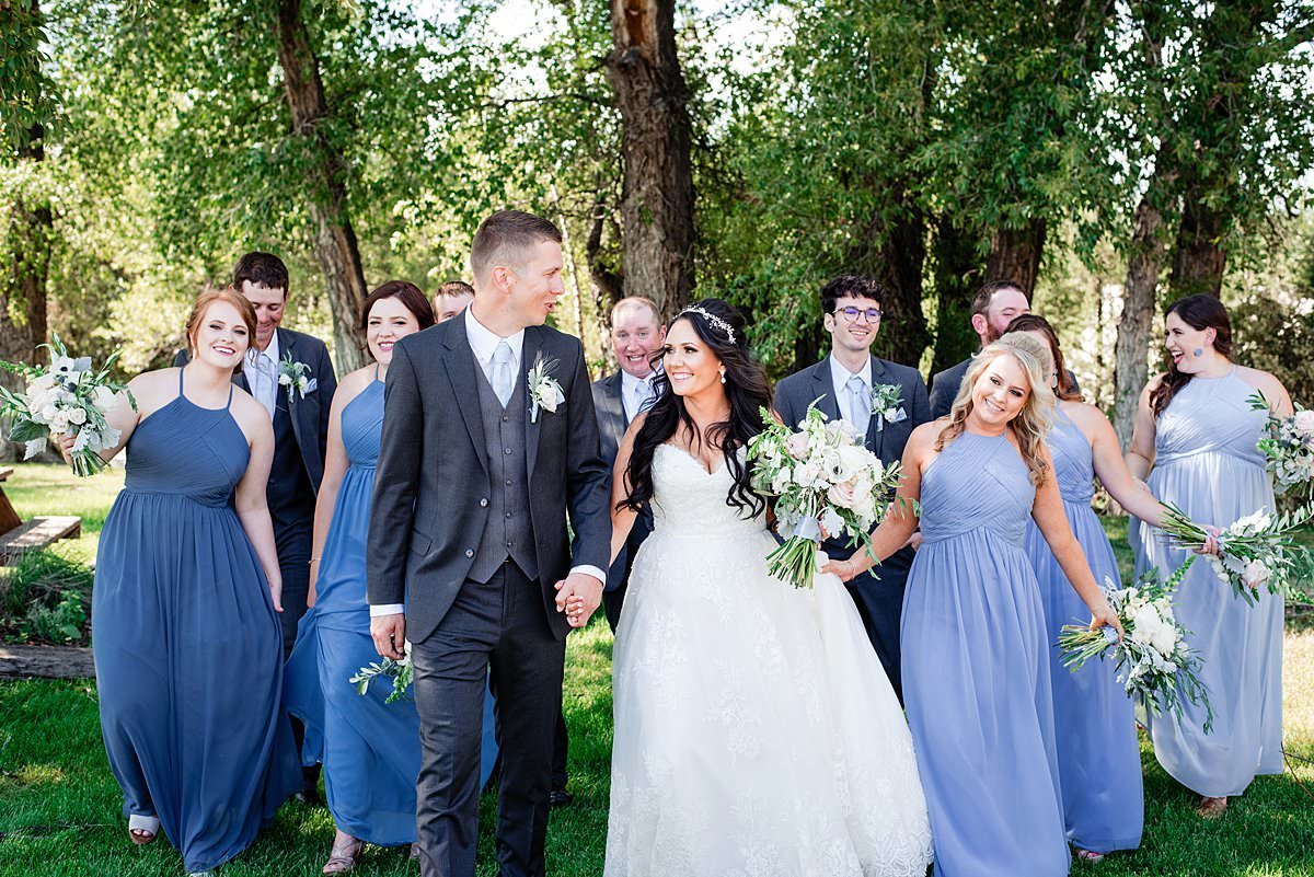 Sunny wedding day with full bridal party walking together