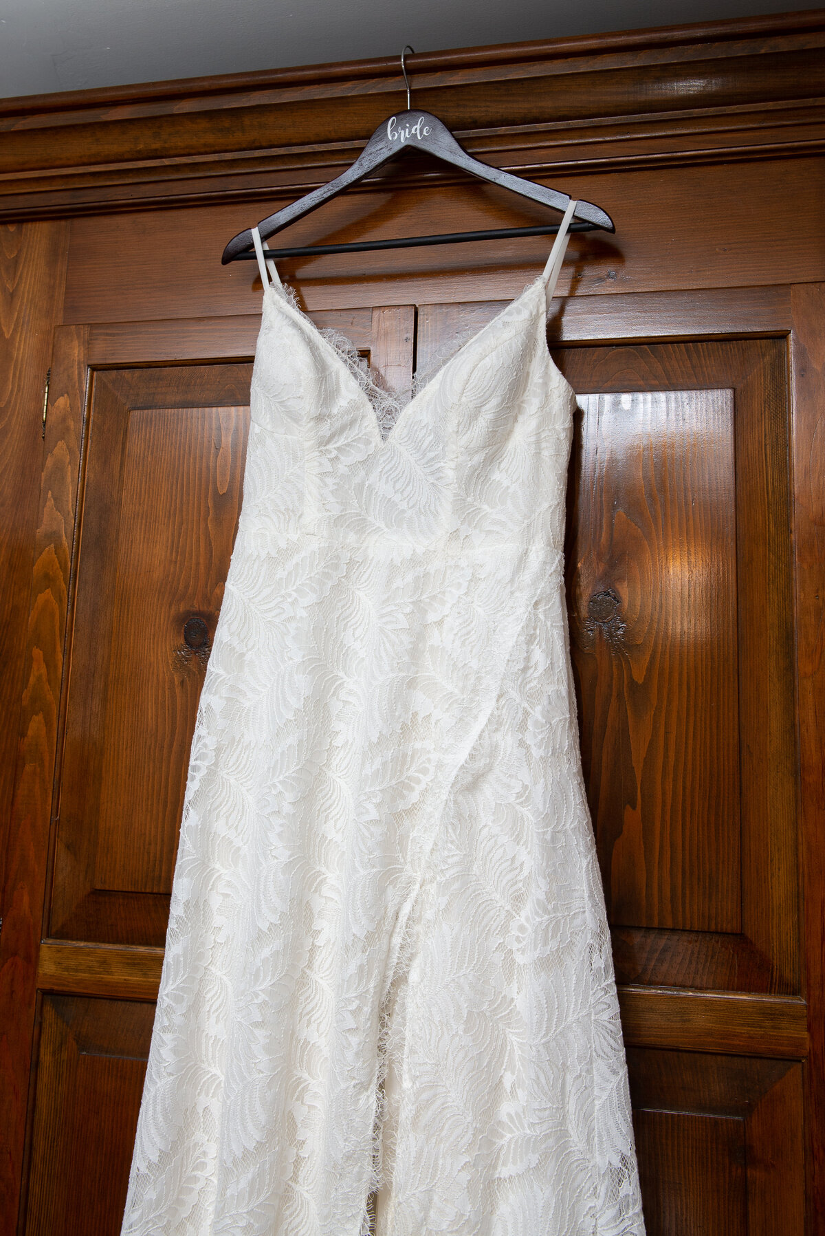 Wedding dress hanging on armoire in Wells Maine