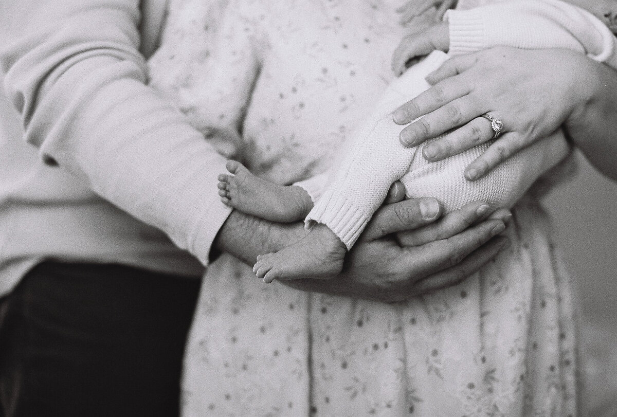 parents holding baby close up