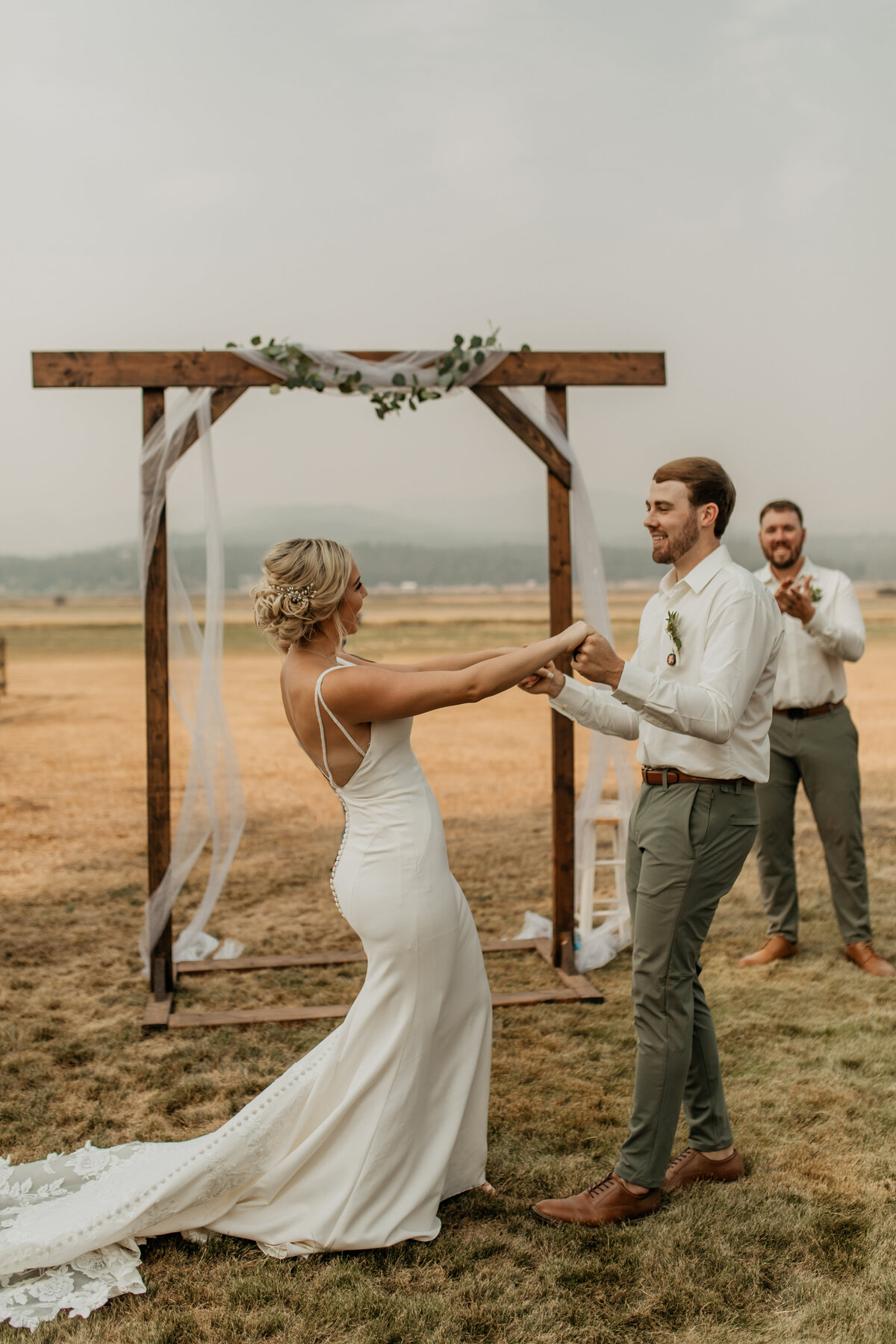 bride and groom hold hands during wedding ceremony