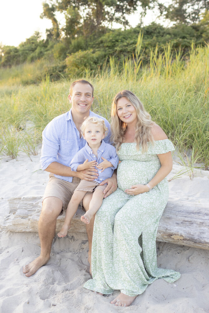 classic family portrait during maternity photoshoot at the beach