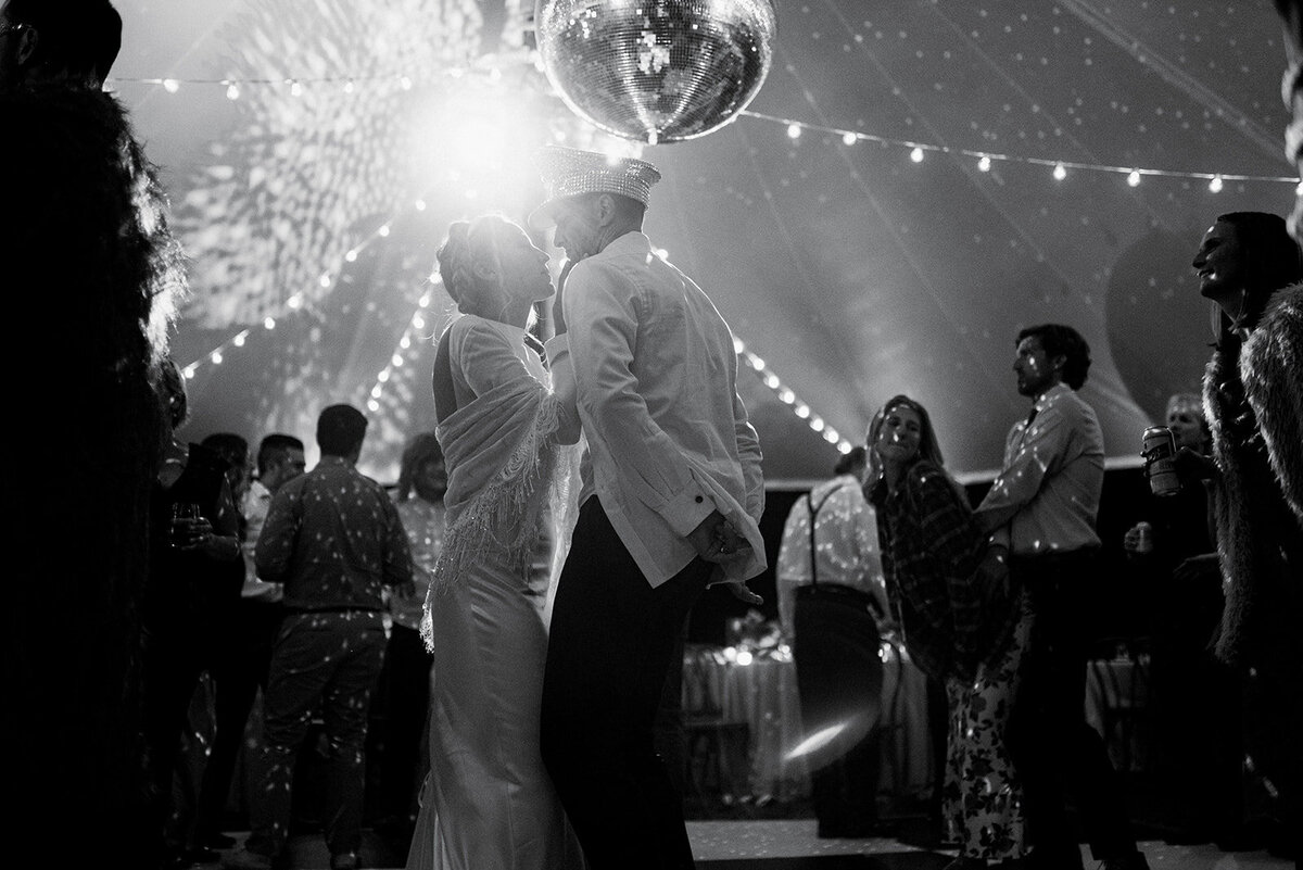 A bride and groom dance at a wedding disco party.