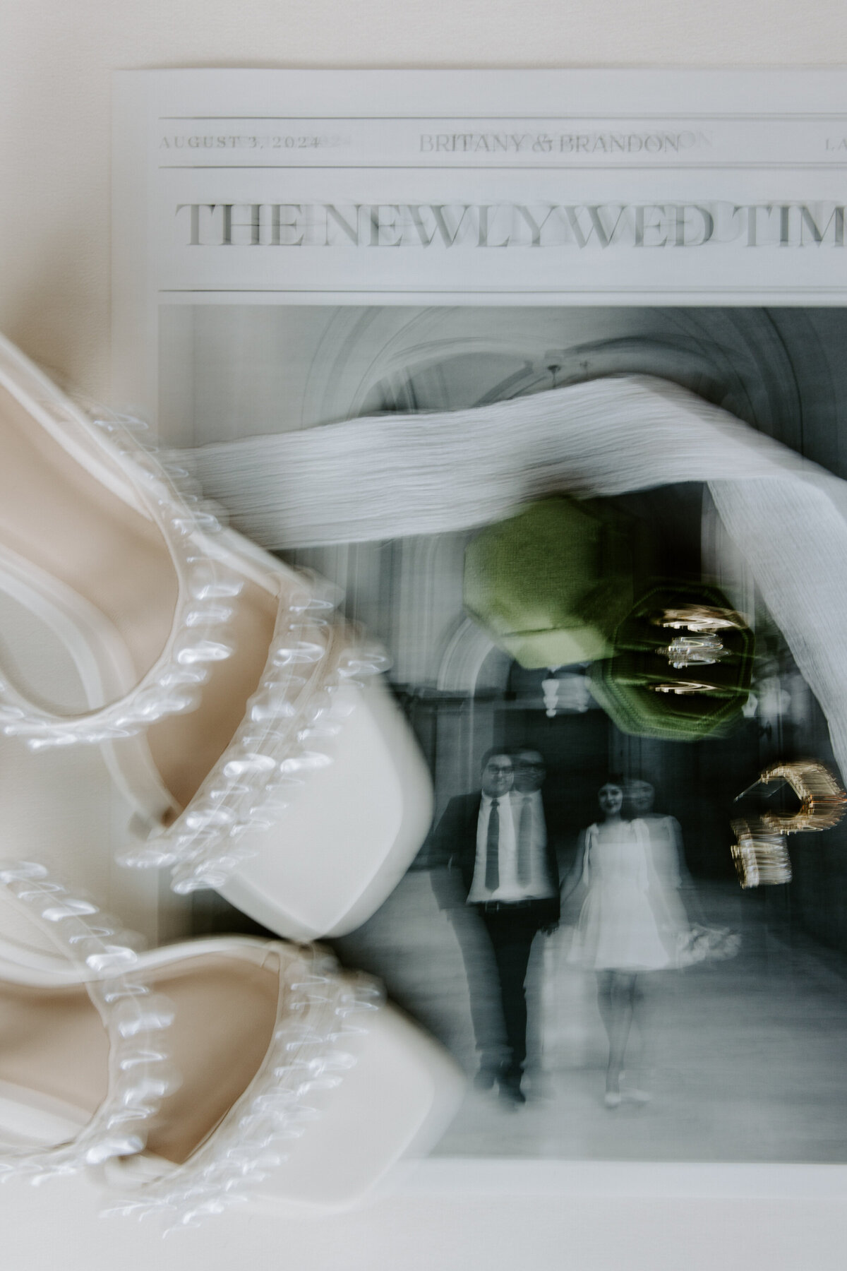 Details from The Doyle wedding featuring a newspaper, ring box, and shoes.