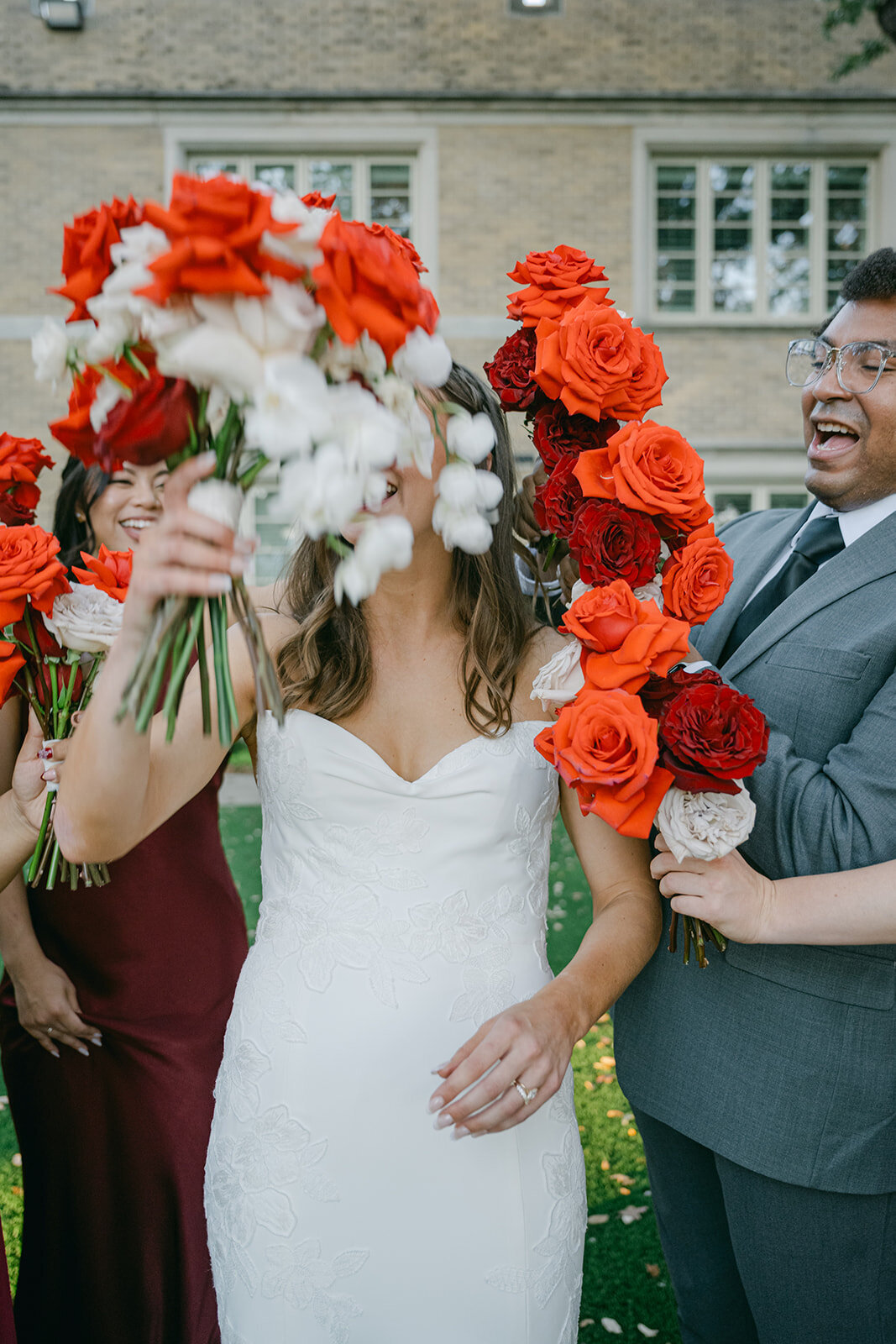 Editorial wedding portrait of bride surrounded by couture red and white florals in San Antonio