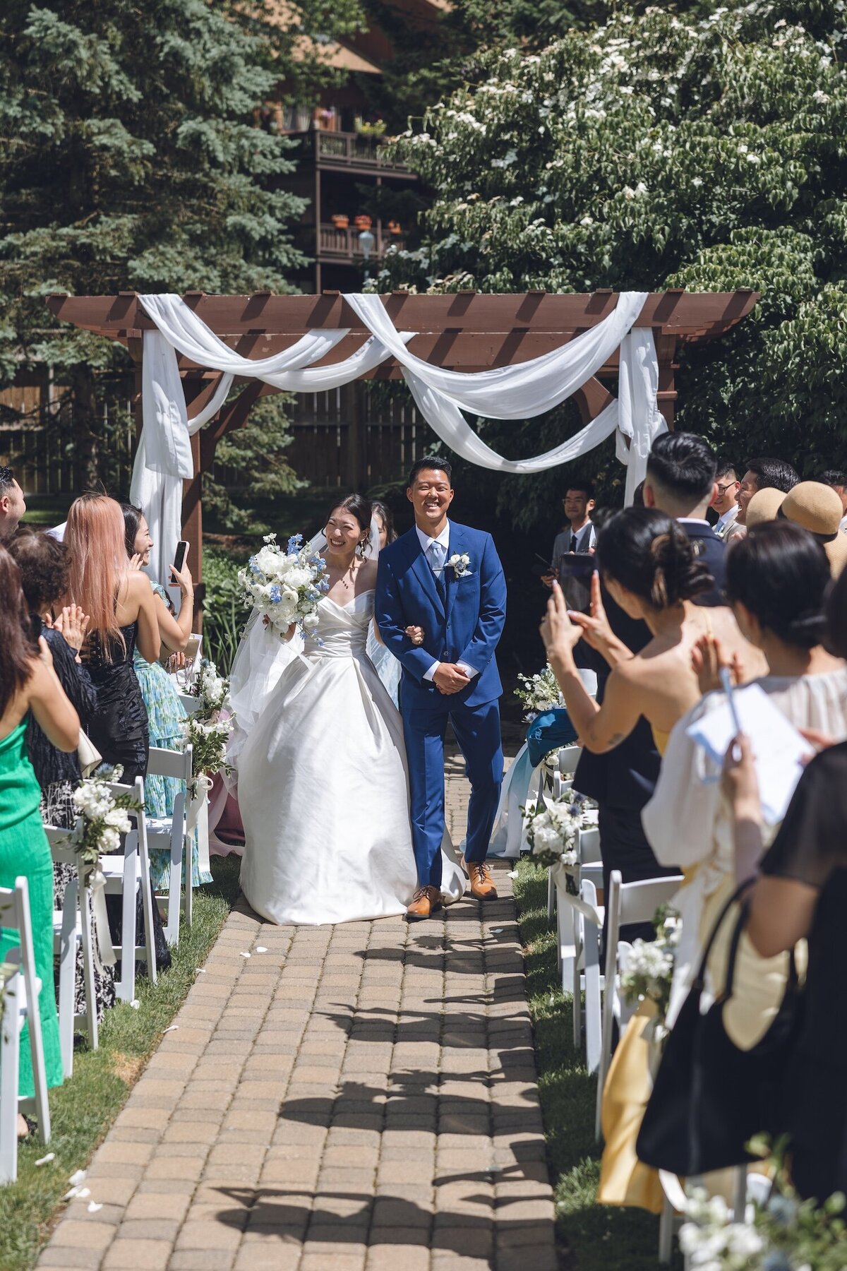 Bride and groom recessing down aisle after ceremony
