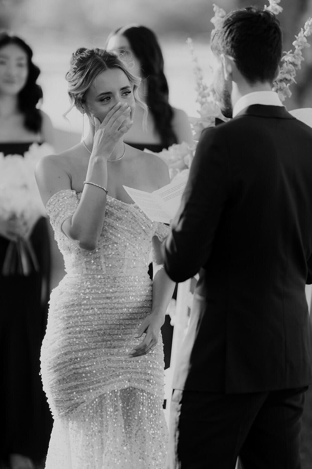 Bride crying during the ready of the vows