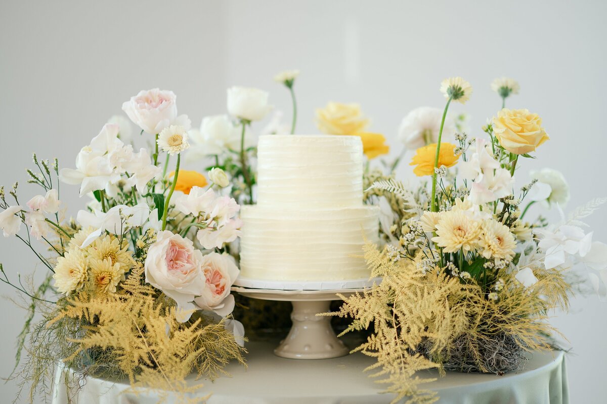 Wedding cake surrounded by spring florals