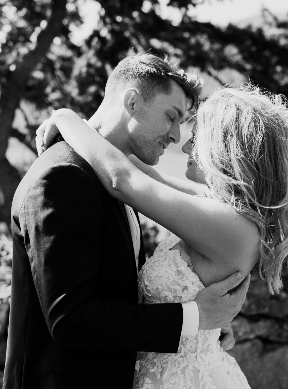 Couple holds each other for a black and white wedding photo