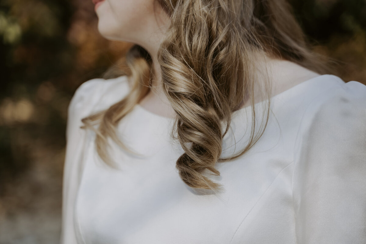 a bride with blonde hair wearing a white wedding dress