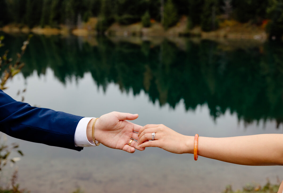bride and groom touch hands at their pnw elopement