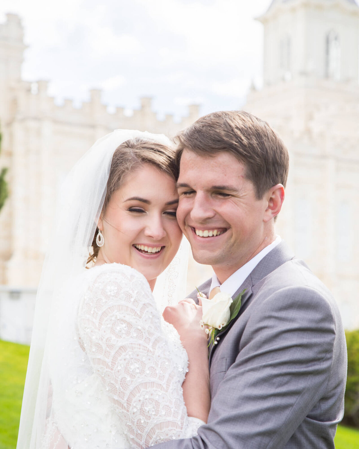 happy bride and groom hugging and laughing together at utah lds temple