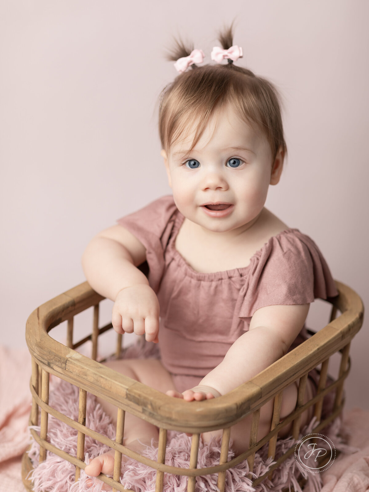 one year old girl in pink for first birthday photoshoot