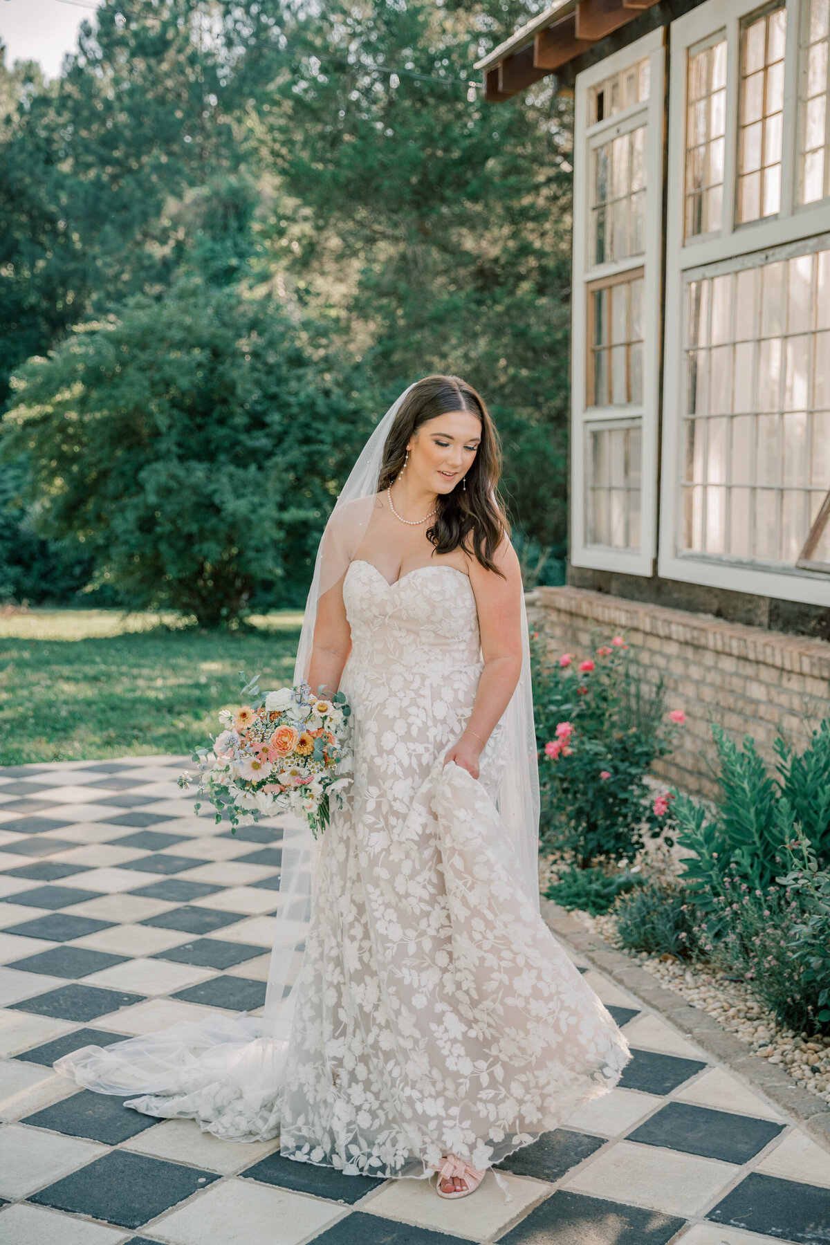 Bride twirls her dress outside of the greenhouse at Three Oaks Manor in Vrginia