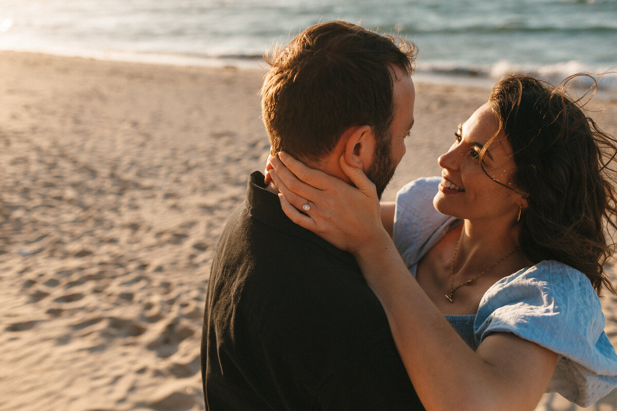 Photograph of a young  engaged couple at the beach