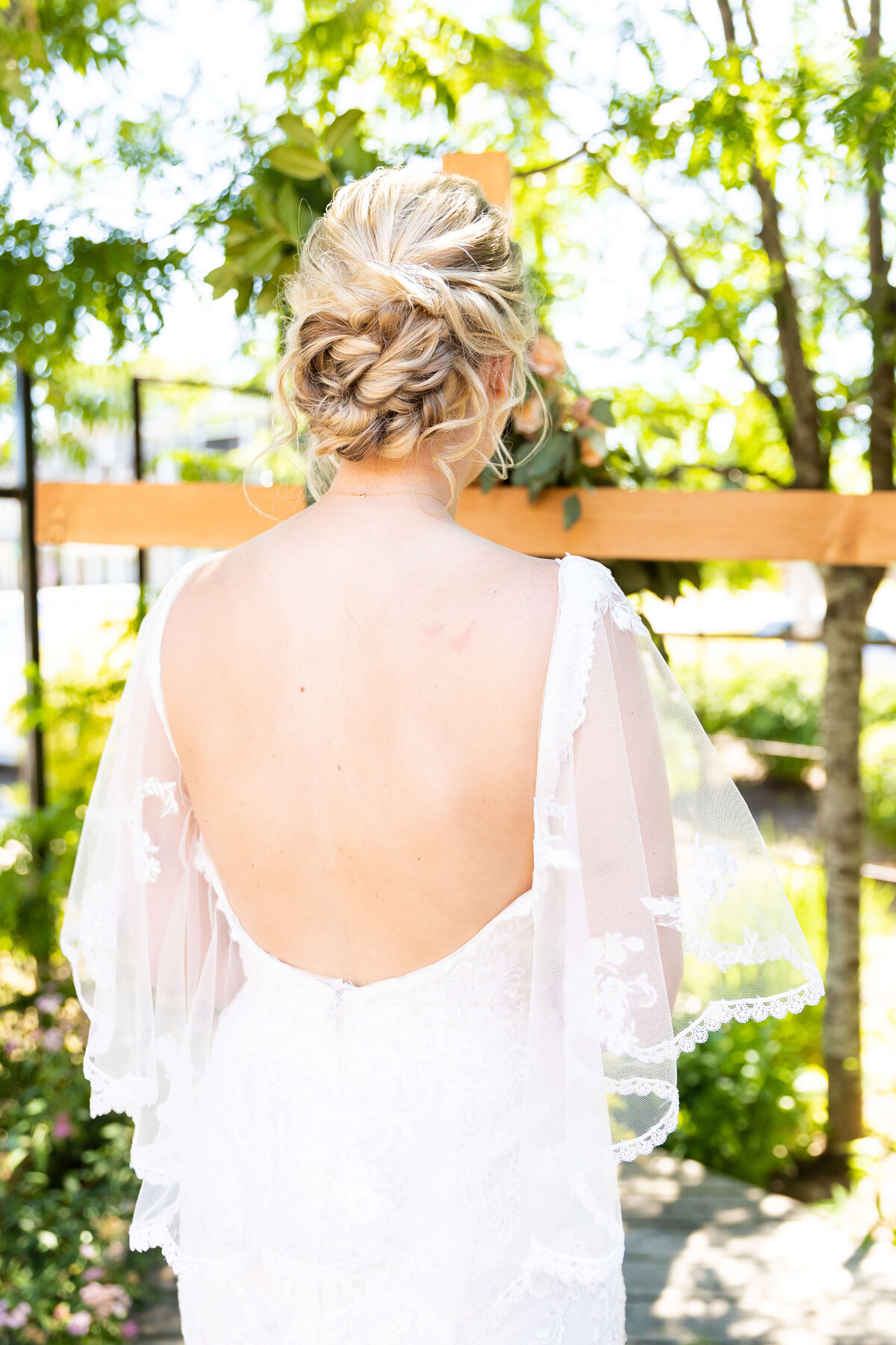 Bride wearing backless wedding gown by Winnie Couture