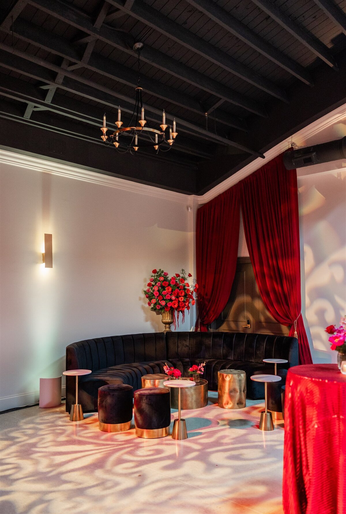 Event space styled with a Baroque theme, featuring ornate gold accents, rich fabrics, grand chandeliers, and intricate moldings, creating a luxurious and dramatic atmosphere