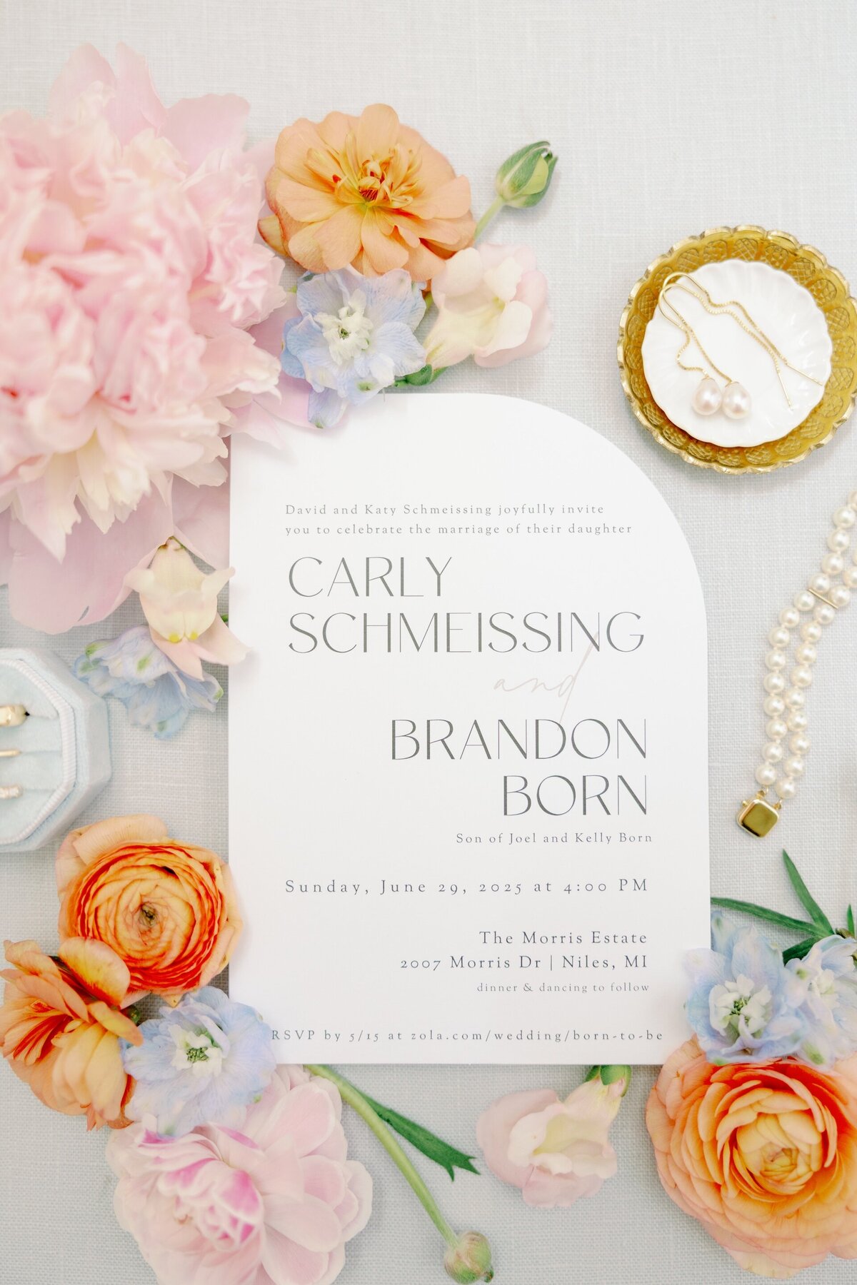 wedding invitation surrounded by colorful flowers