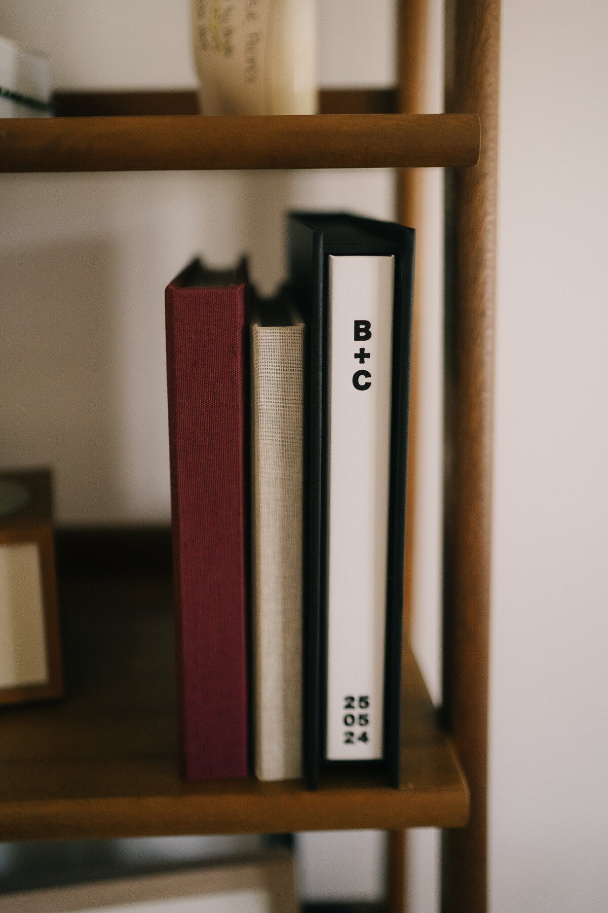 three fine art books on bookself designed by melbourne wedding photographer