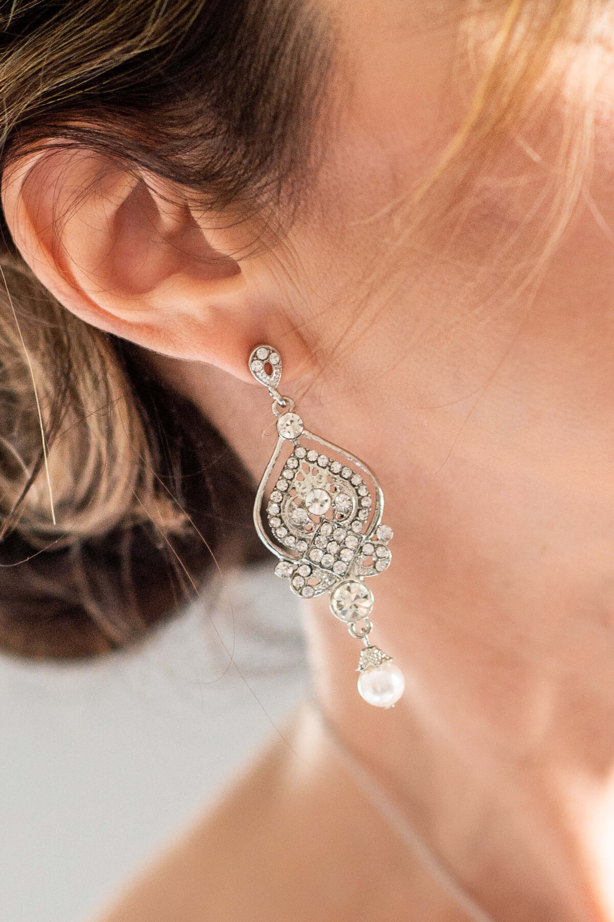 Ottawa wedding photography showing the closeup diamond and pearl details of a bride's earrings on her wedding day