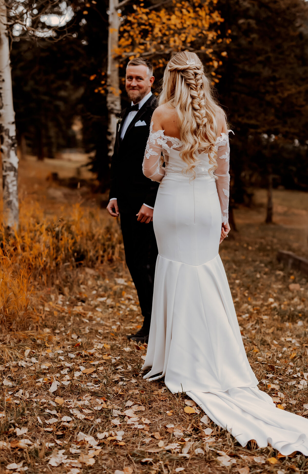 Groom seeing his bride for the first time in Pine, Colorado during their fall wedding
