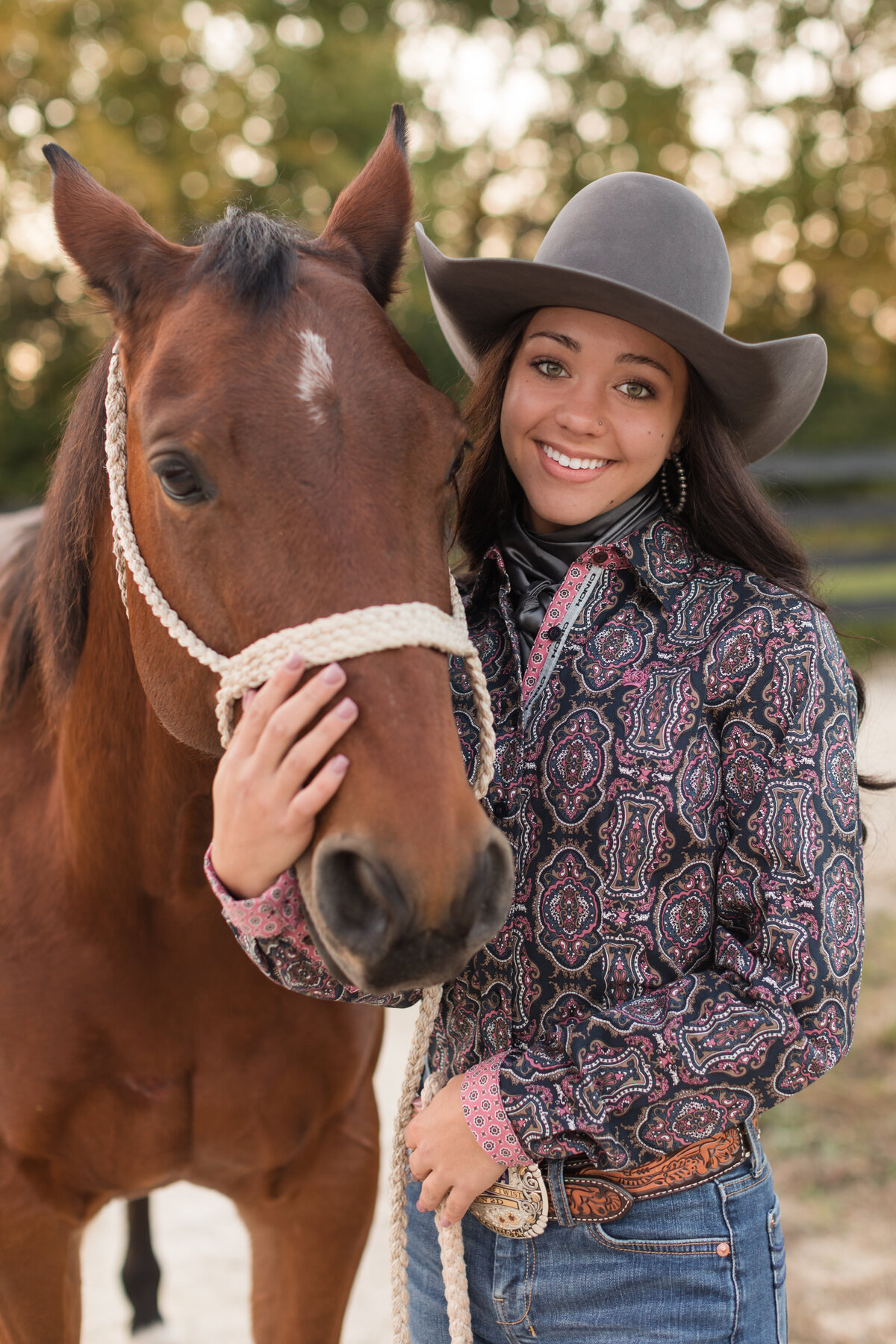 Senior girl with her horse smiling at the camera