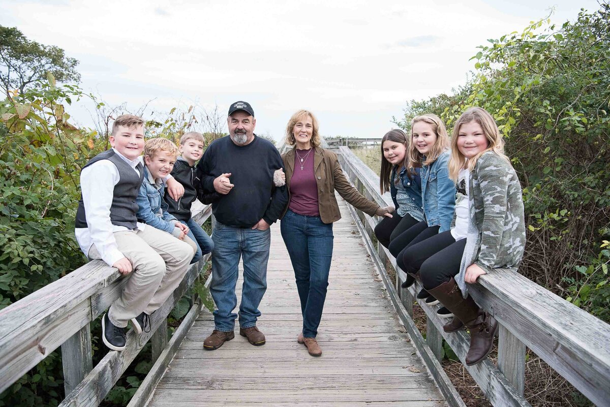 Grandparents standing on a boardwalk with their grandkids