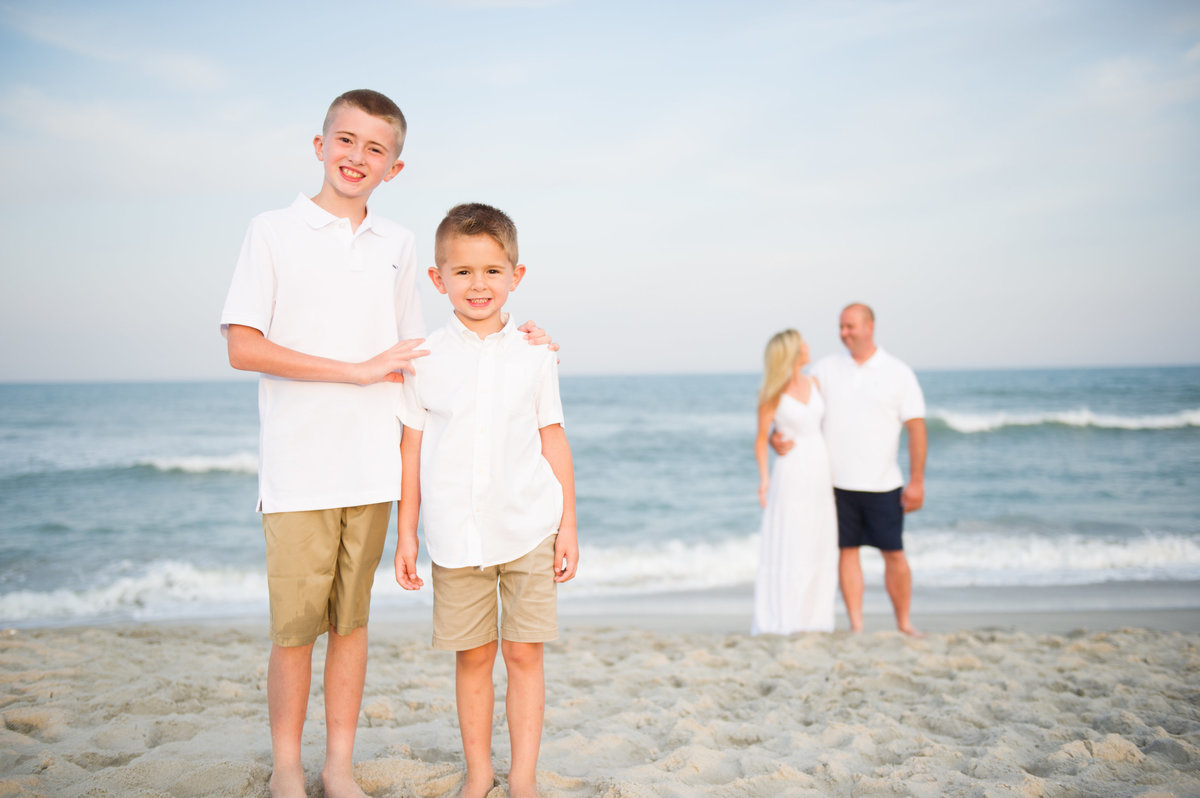 two boys and parents on beach