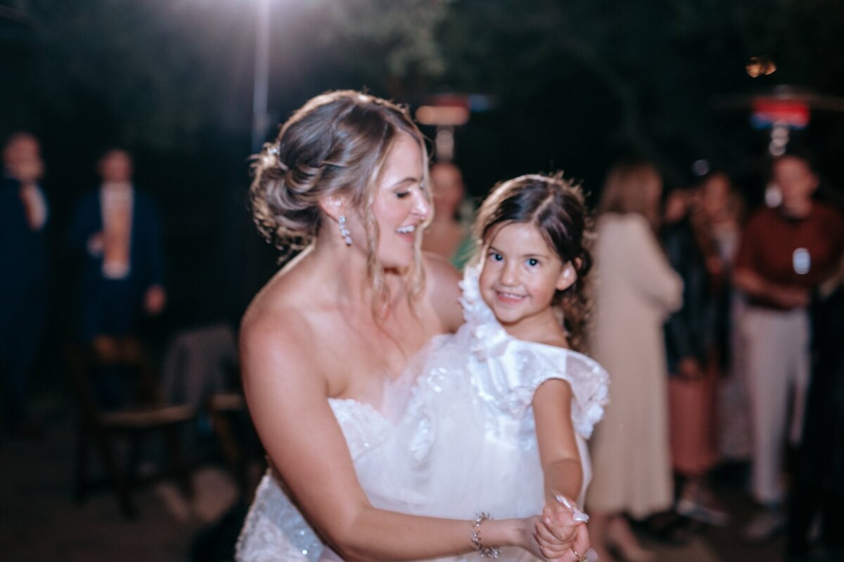Bride dancing with the flower girl at the reception.