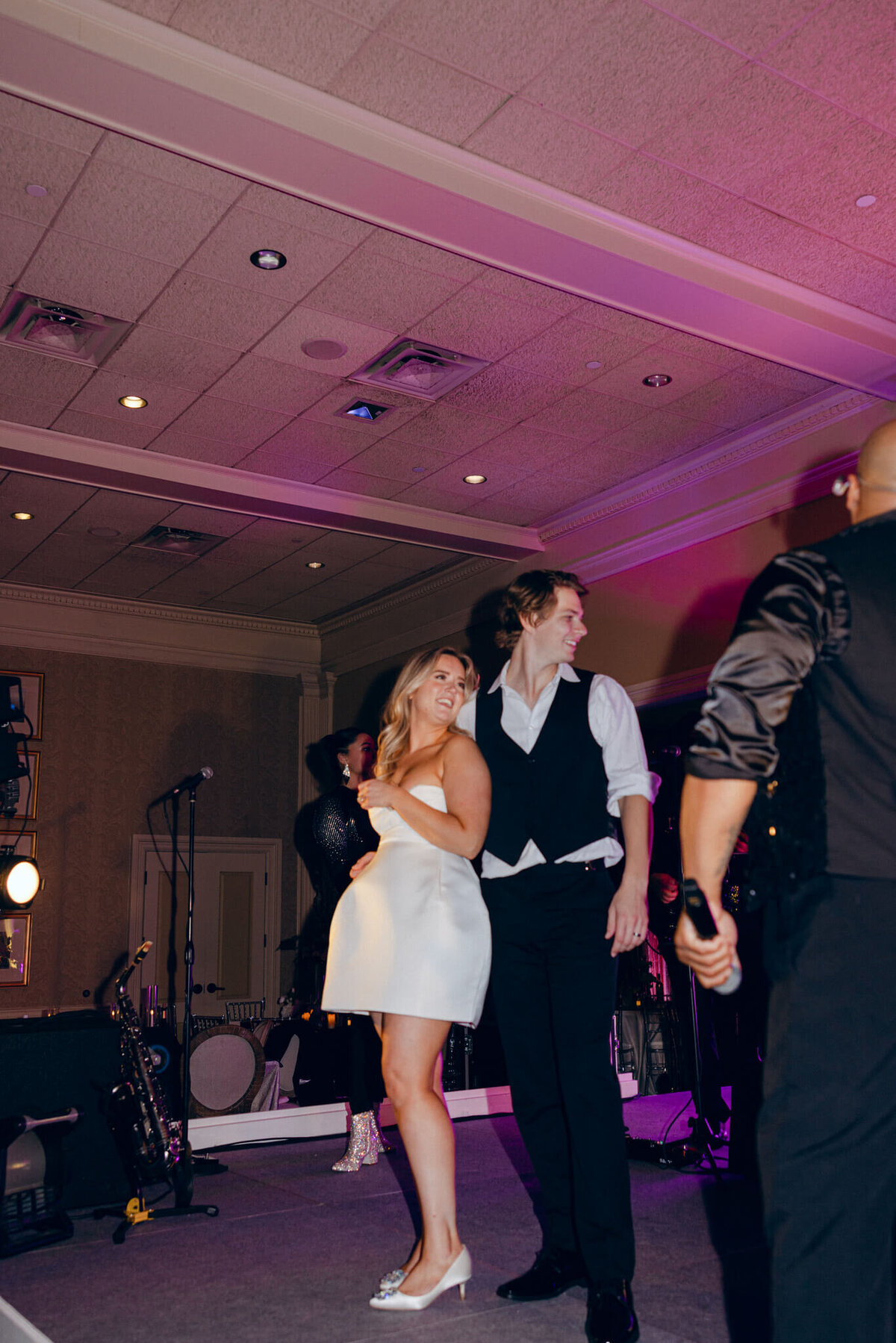 A wedding photo oft he bride and groom dancing during the wedding reception