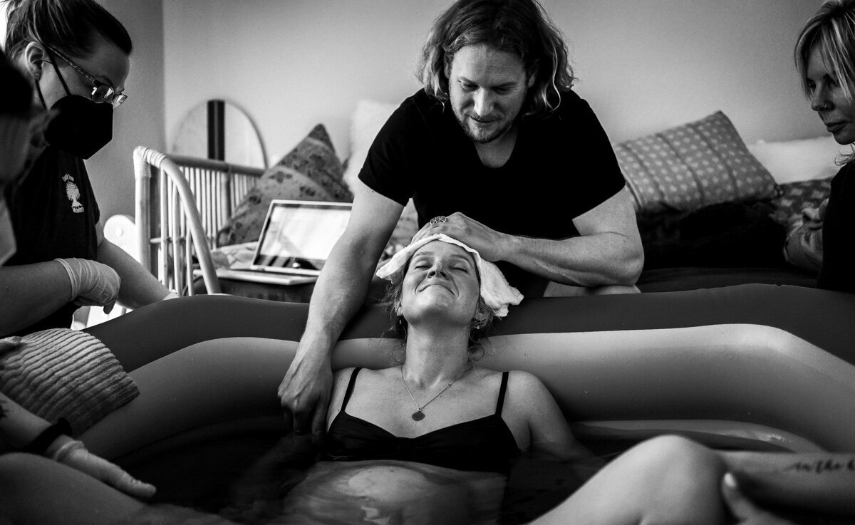 A dynamic image of the mother during labor, showing her strength, determination, and the incredible physical and emotional effort of bringing life into the world.