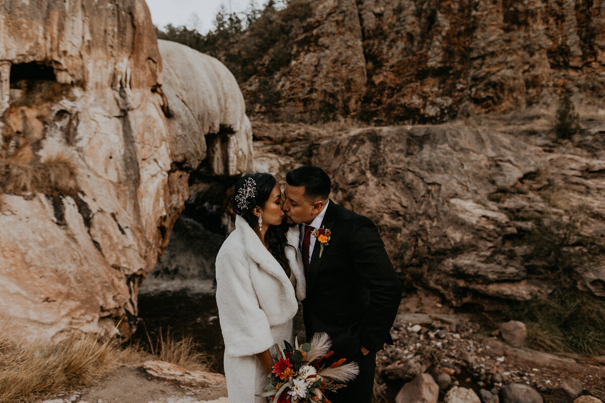 newlyweds holding each other and kissing