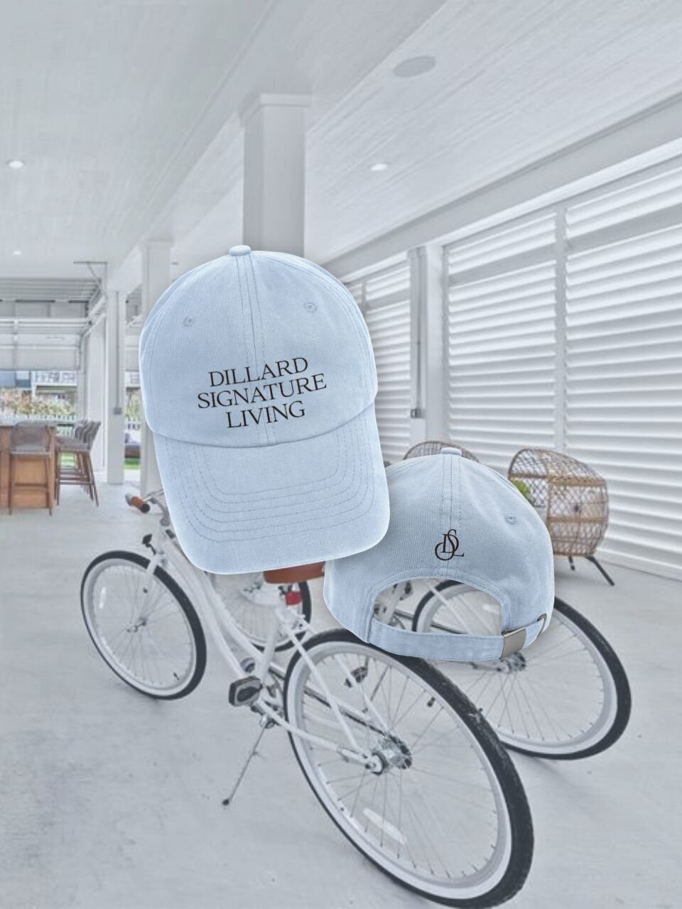 Branded baseball cap in coastal blue with "Dillard Signature Living" embroidered on the front and monogram on the back, shown in a breezy Gulf-side setting.