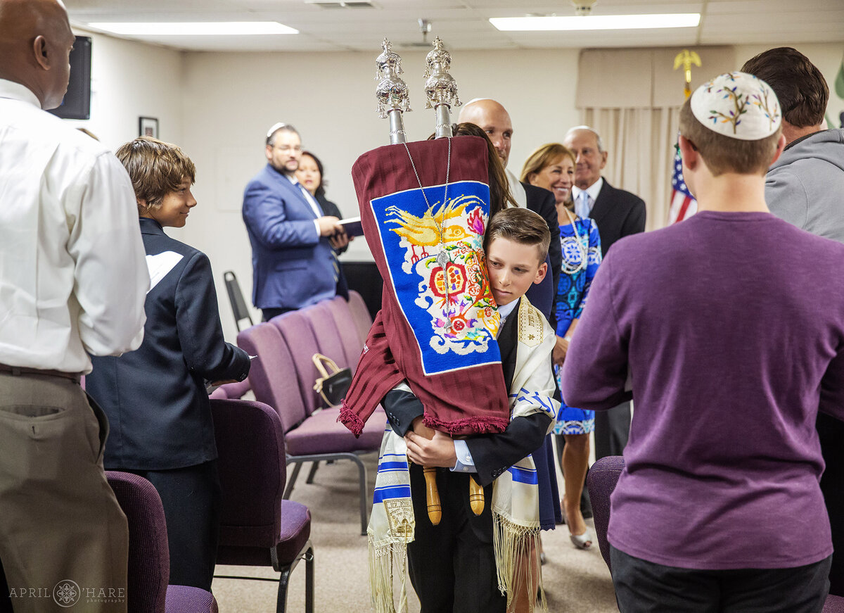 Young Man Carries the Torah Around at his Bar Mitzvah in Denver CO