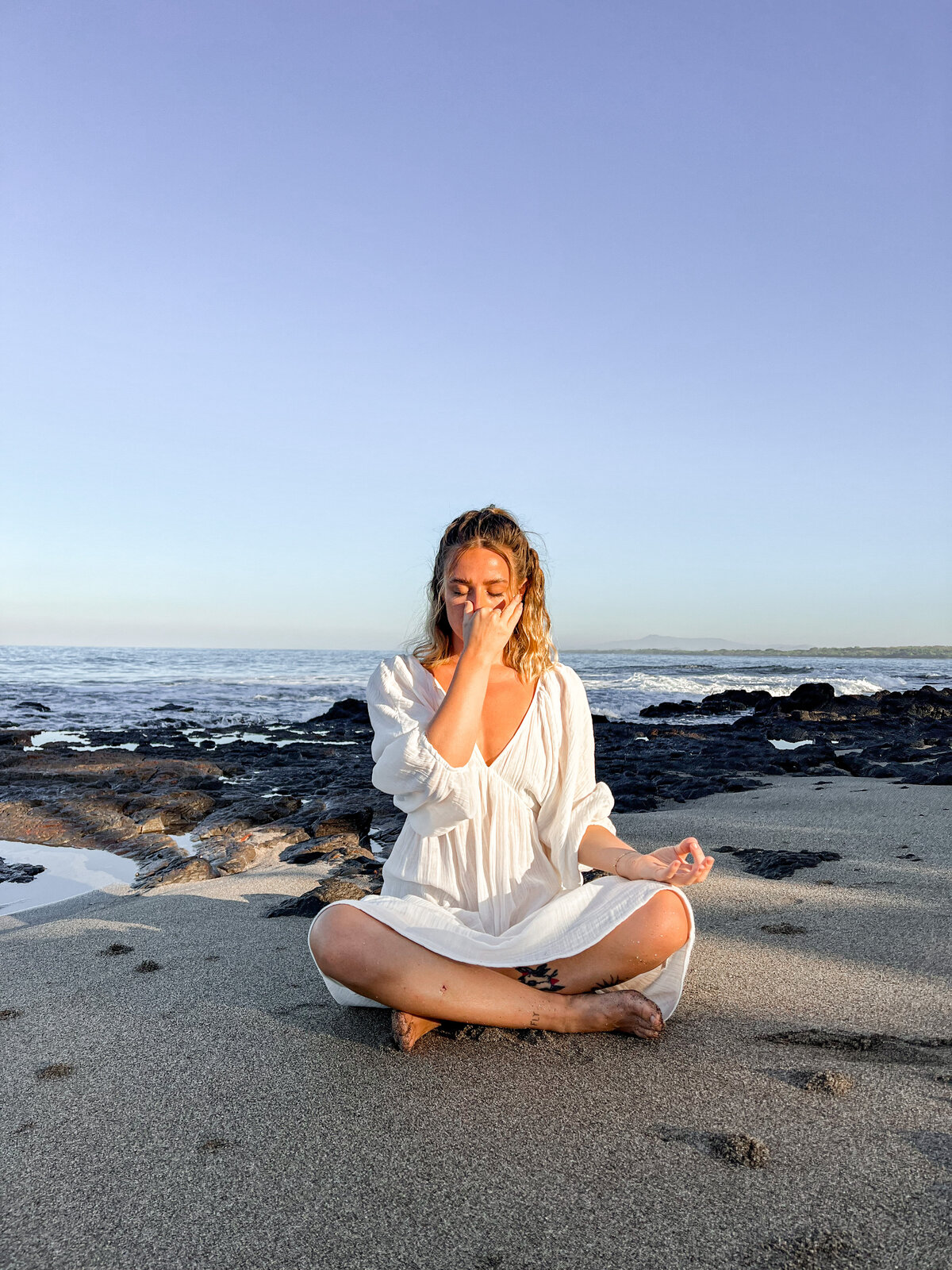spiritual yoga woman on beach doing breathwork
