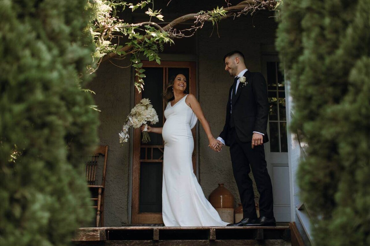bride_groom_smiling_at_top_of_stairs