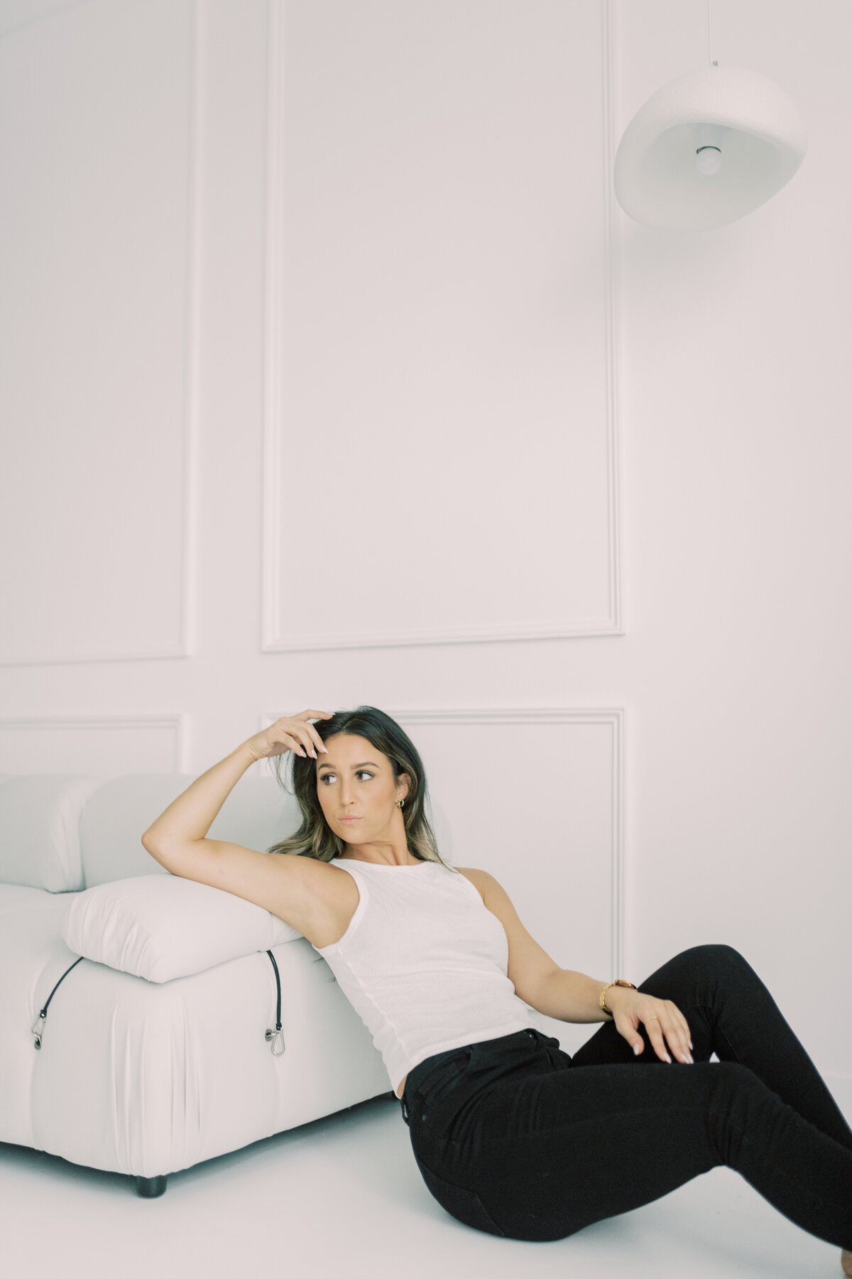 Modern editorial-style headshot of woman reclining 