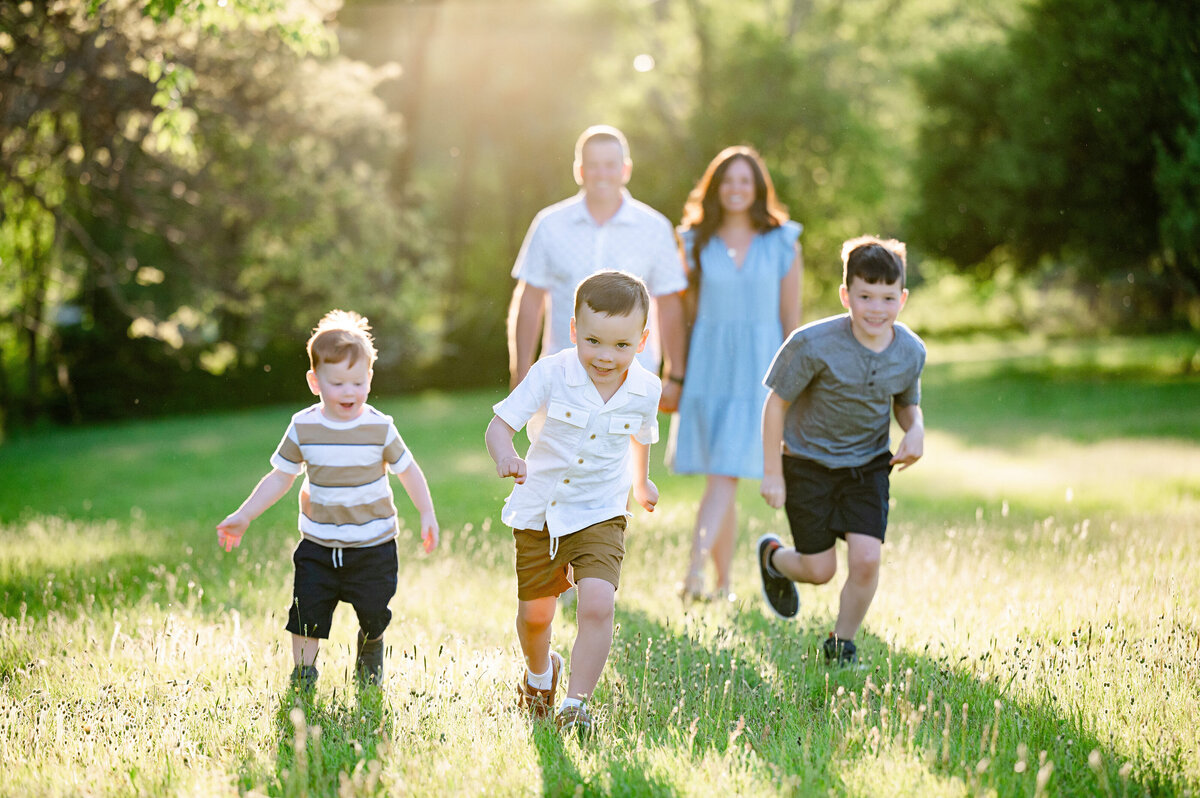 boys running in a field at leeann marie photography studio