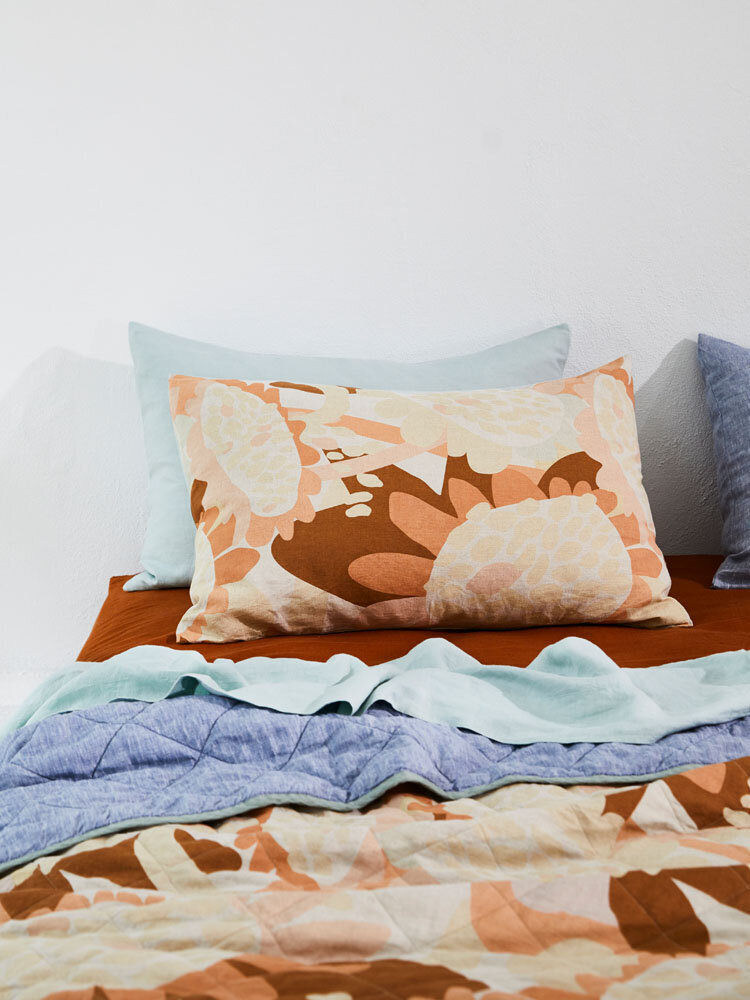 Bedroom styling Melbourne with floral patterned pillow and quilt designed by interior decorator service for residential design interiors.