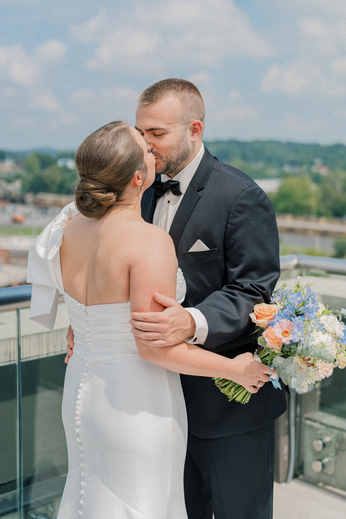 Bride and Groom share a kiss on the rooftop of the Bristol Hotel before their Bristol Train Station wedding.