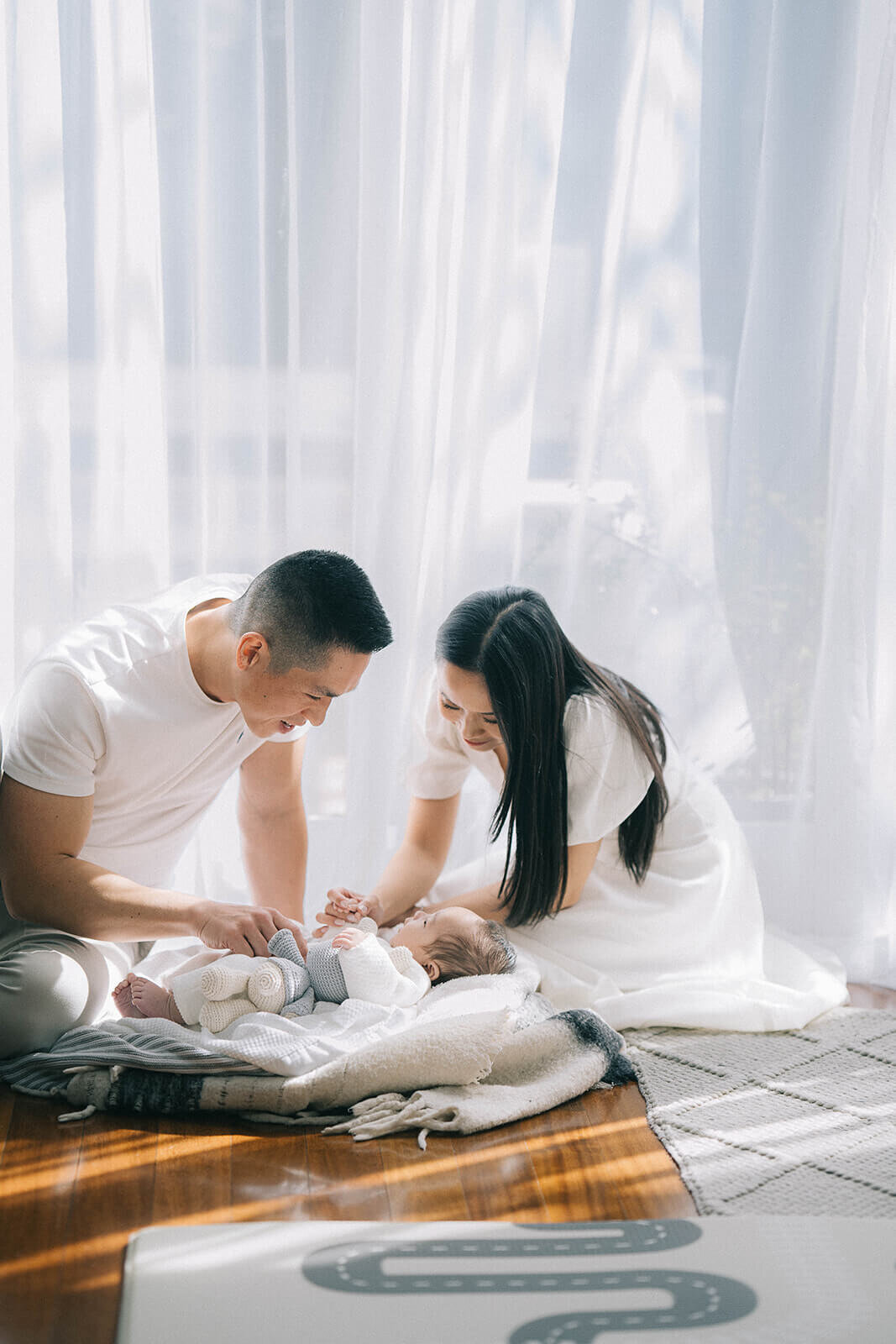 new-parents-and-baby-playing-at-home