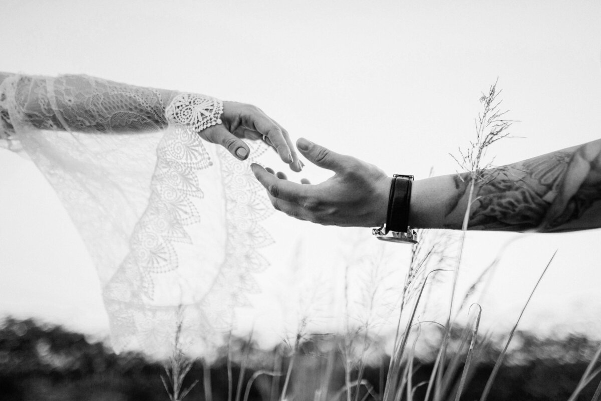 Boho Bride and Groom touching fingers bw