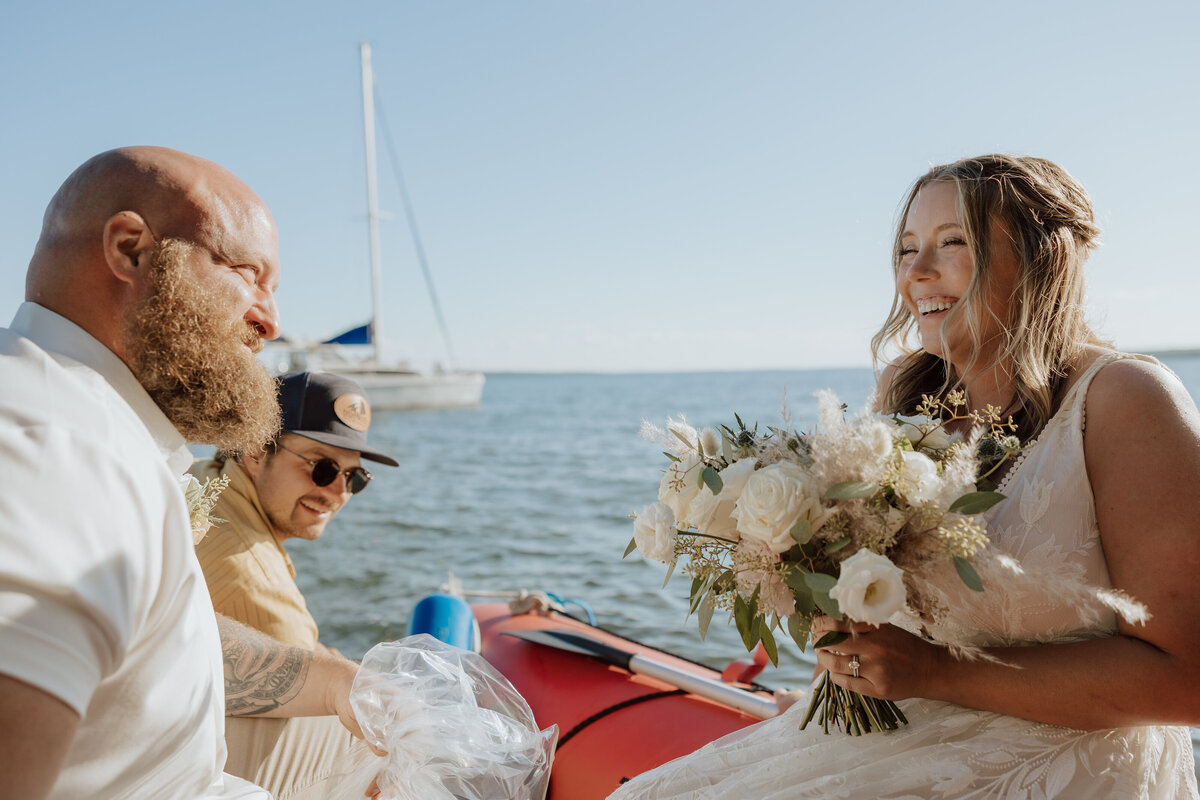 bride and groom on a red raft boat