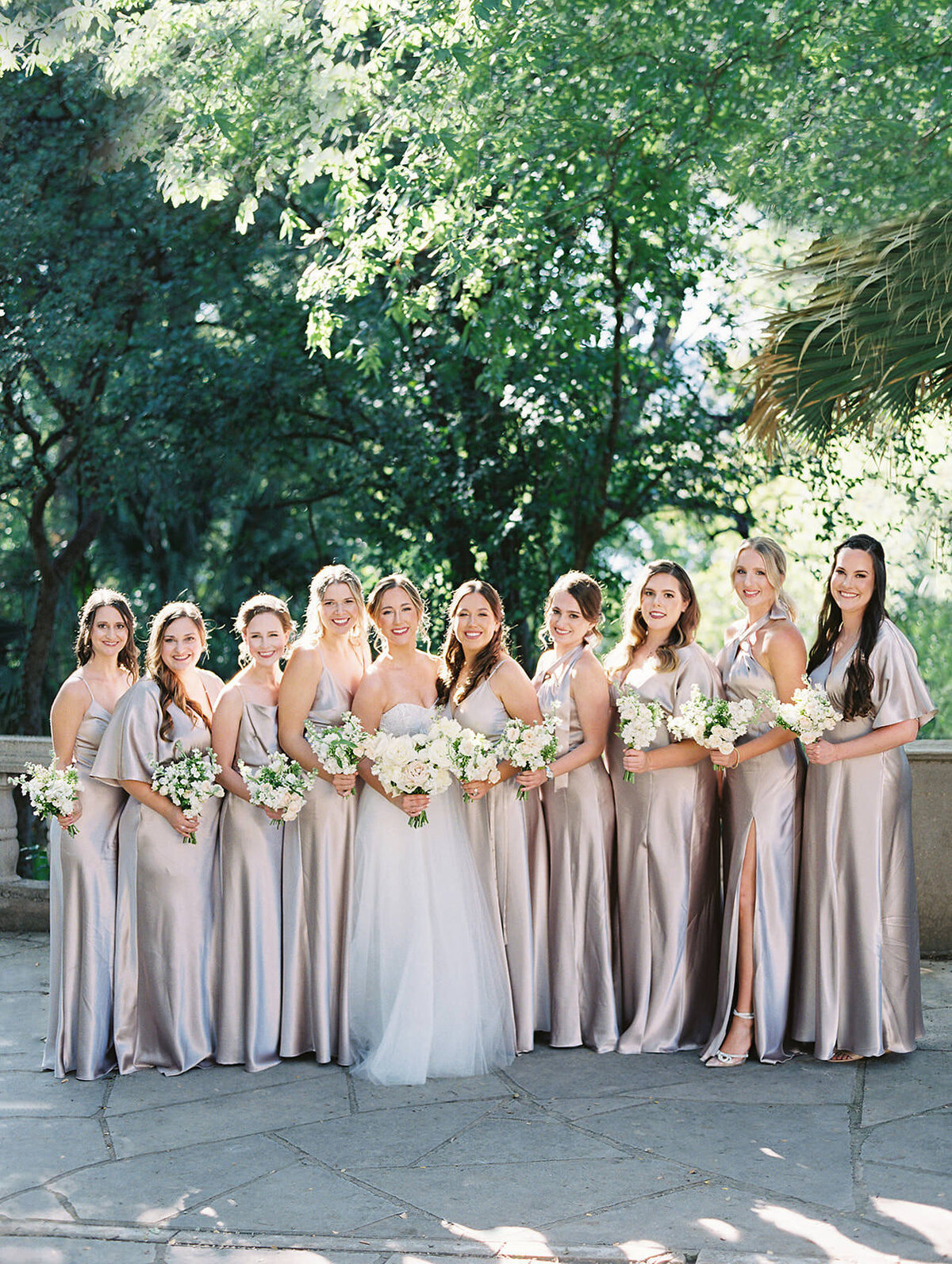 The bride poses with her bridesmaids at Laguna Gloria