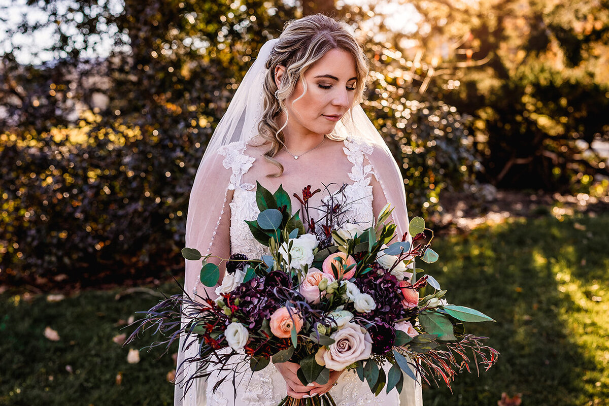 Bridal portrait of bride with beautiful lush flower bouquet at sunset at the Wentworth Inn in Jackson NH by Lisa Smith Photography