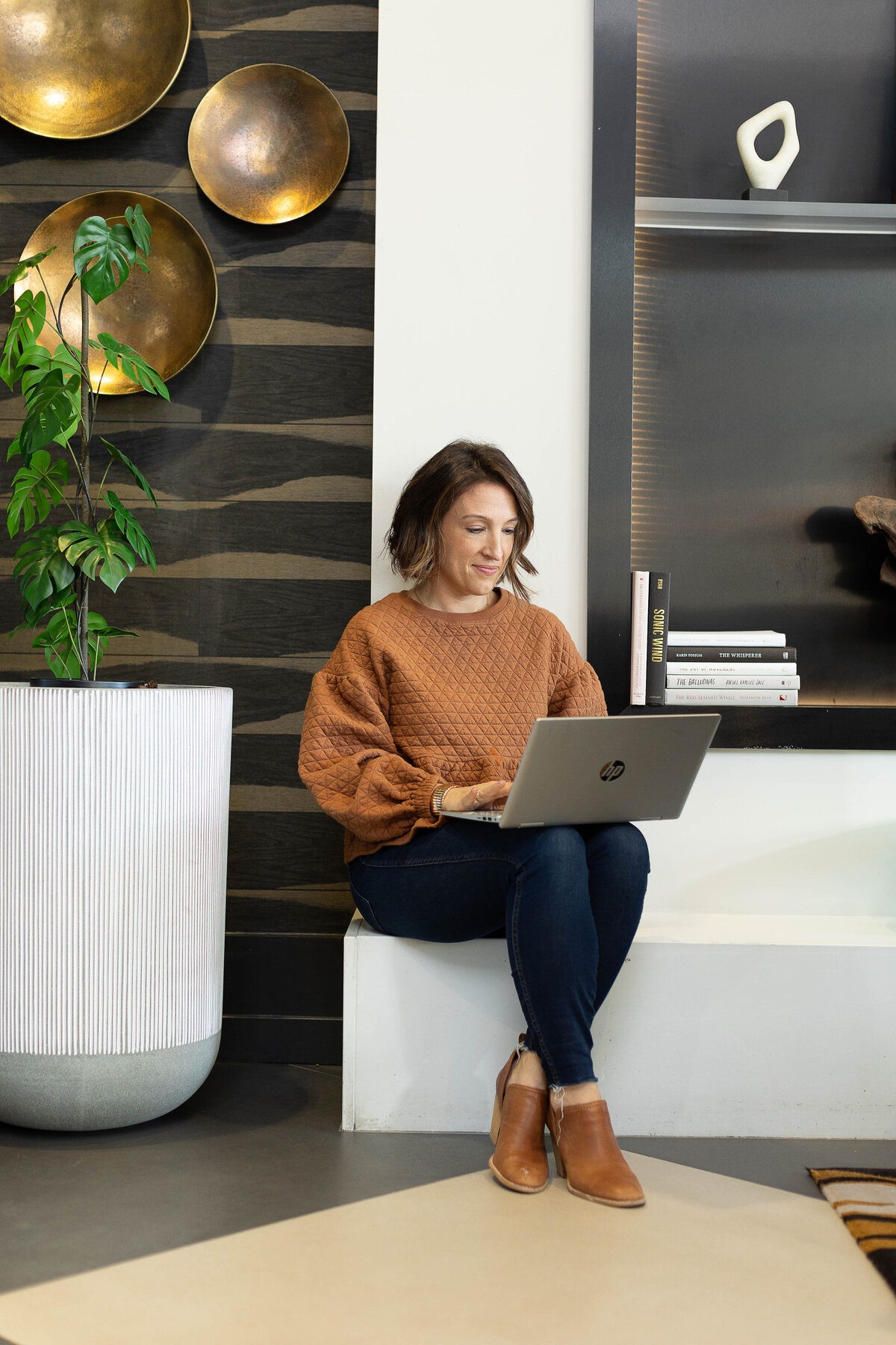Woman seated in fancy lobby using a laptop