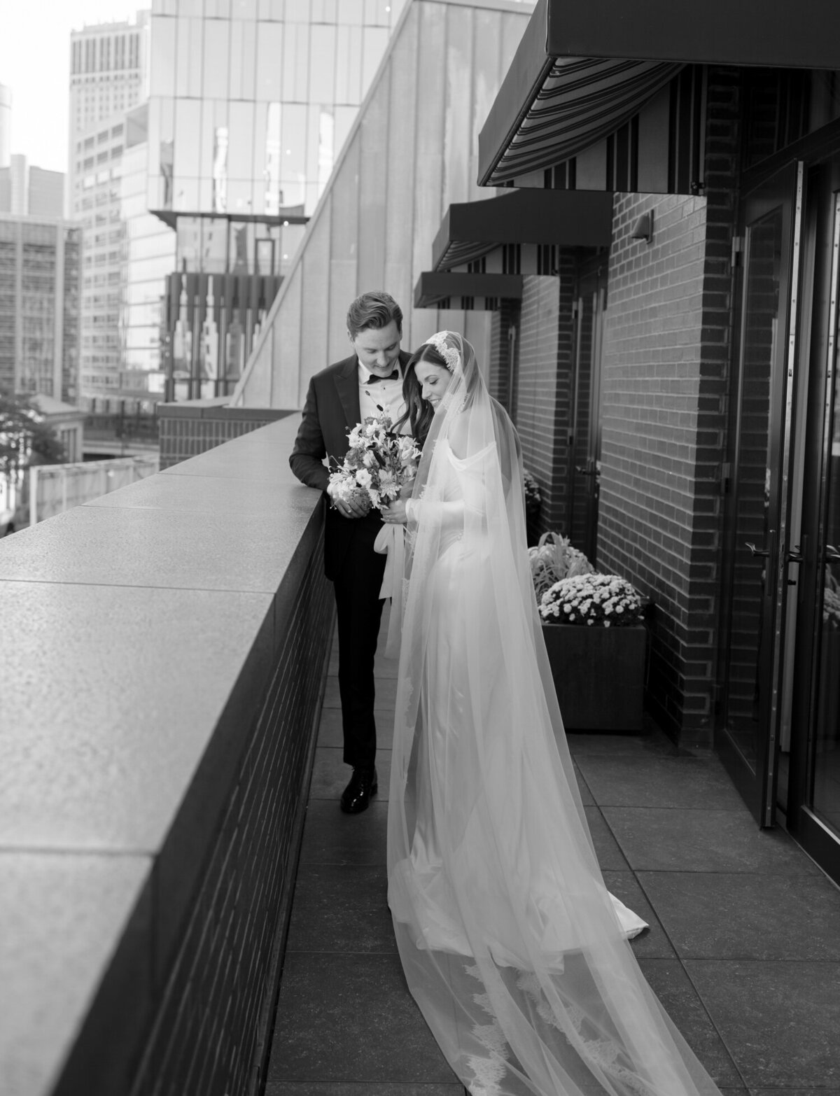 couple first look wedding at Shinola Hotel with bride in long lace cathedral veil